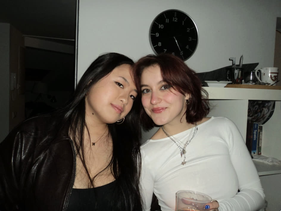 Two friends smiling together at a get-together