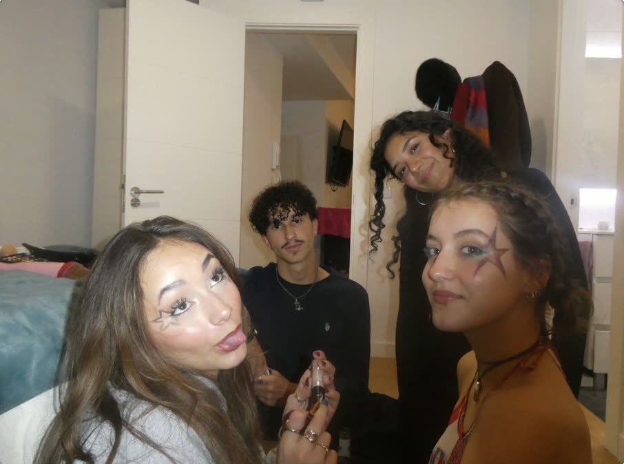 Friends doing star face paint together before going out